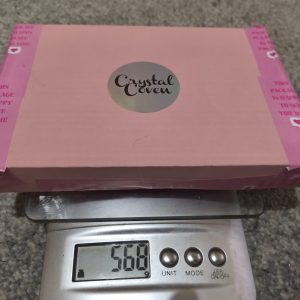 Crysta mystery box on a scale weigning 568 grams
