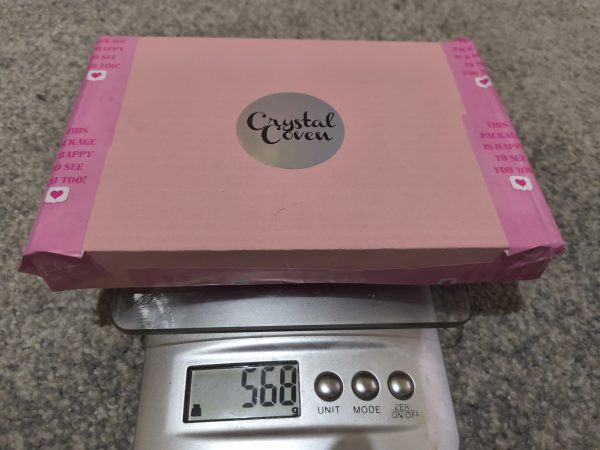 Crysta mystery box on a scale weigning 568 grams